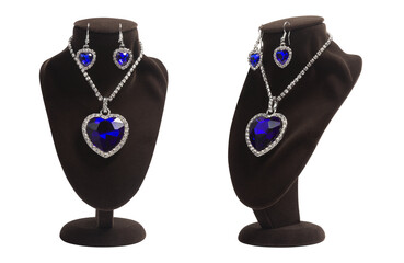 Luxurious jewelry set with blue heart shape diamonds: pendant and earrings on mannequin. Fashion jewelry, symbol of love, isolated. Present for women.