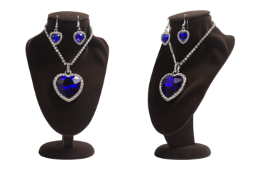 Luxurious jewelry set with blue heart shape diamonds: pendant and earrings on mannequin. Fashion jewelry, symbol of love, isolated. Present for women.