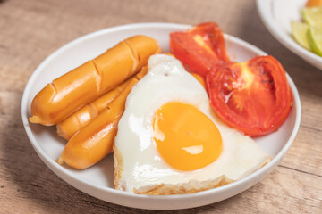 Sausages on a white plate for breakfast