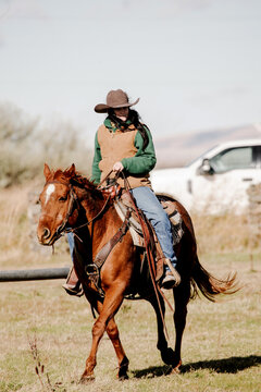 woman rancher prepares to check cattle horseback