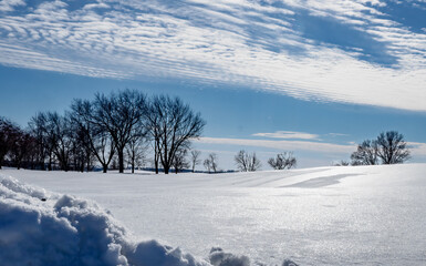 Ice covered snow on a blue sky day