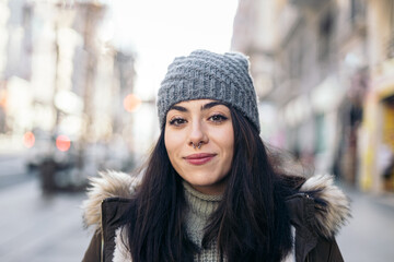 Portrait of a cheerful young woman in winter clothes