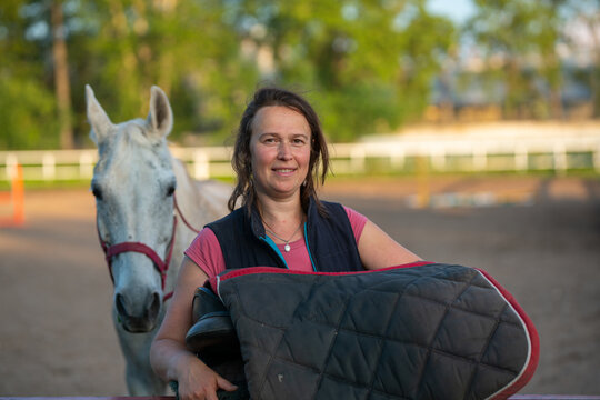 smiling Horsewoman in equestrian center