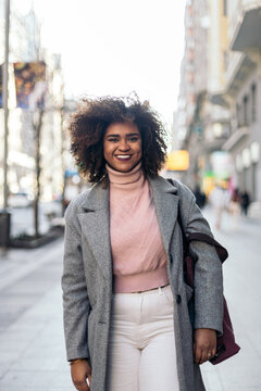 Portrait of a black woman wearing winter clothes in the city