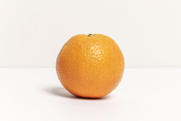 A delicious whole orange with its characteristic rough skin