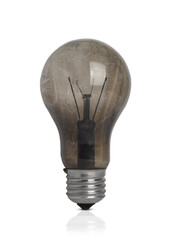 The concept of lack of electricity. Burnt, broken light bulb isolated on white background.