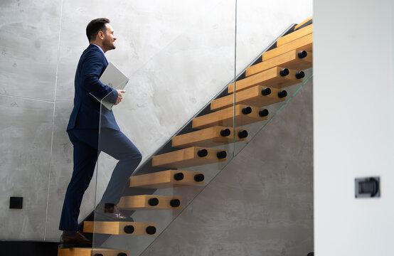 A successful businessman is climbing the stairs