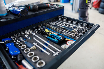 Close up of a drawer on a toolbox with auto-mechanic tool at garage.