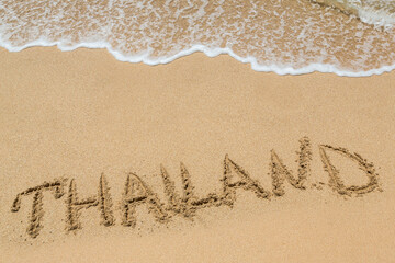 Thailand written in a sandy