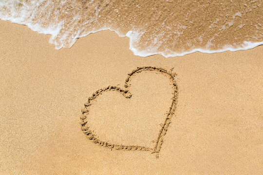 Heart symbol written in a sand