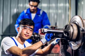 Professional two labor machanic engineer technician worker industrial man wearing blue safety uniform working control with heavy machine in manufacturing  factory production line.business industry