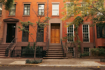 Fototapeta na wymiar Facade of building with steps and doors on urban street in brooklyn heights in New York City.