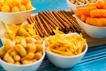 Party food. Salty snacks served as party food in bowls