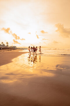 A Group Of Asian Women Is Running With Their Friends Happily On The Beach