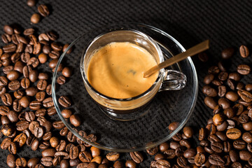 Coffe beans and beautiful cups made of glass.