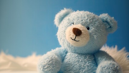 Baby blue teddy bear on light blue background. Soft cuddly stuffed animal. Baby shower for newborn. It's a boy.