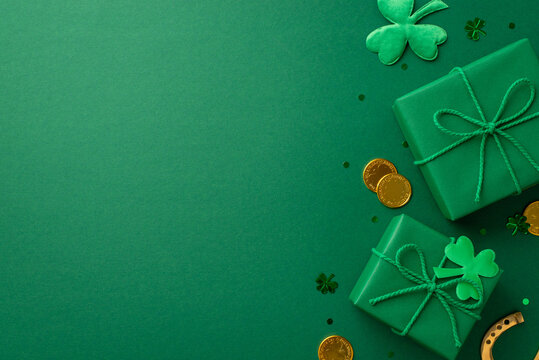 Saint Patrick's Day concept. Top view photo of gift boxes gold coins shamrocks horseshoe and clover shaped confetti on isolated green background with copyspace