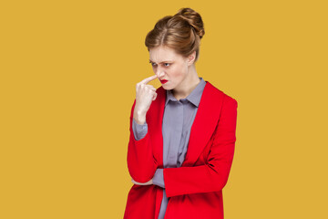 Portrait of young adult woman with red lips standing keeps finger on nose, disbelief saying you are...