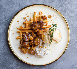 waffles, with berries, nuts & fruit on a gray table, served with ice cream breakfast, no people, horizontal,