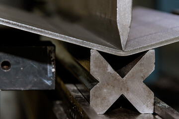 An hydraulic machine, which has been designed to bend sheet metal, is used for bending the sheet metal. Metalwork.