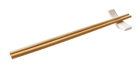 Wooden chopsticks on a white chopstick rest cutout. Pair of bamboo chopsticks on a porcelain holder...