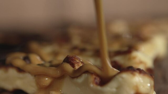 Coalho cheese close up with cane molasses covering it in slow motion