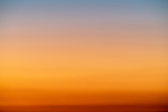 The dramatic colors of the sunset in the sky gradient from blue to orange.