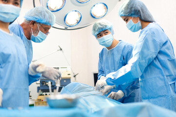 Professional anesthesiologist doctor medical team and assistant preparing patient to gynecological surgery performing operating with surgery equipment in modern hospital operation emergency room