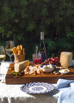 Charcuterie Board With White Wine Outdoors