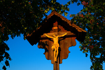 Jesus Christ on the cross in blooming chestnut trees.Christian and catholic faith symbol.Religious...