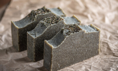 Natural herbal handmade soap on the background of craft paper. Concept of create and use organic eco soap and cosmetics
