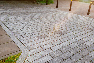 View on grey stone sidewalk. Footpath covering