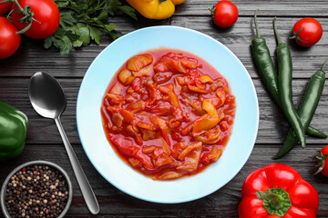 Delicious lecho and fresh ingredients on wooden table, flat lay