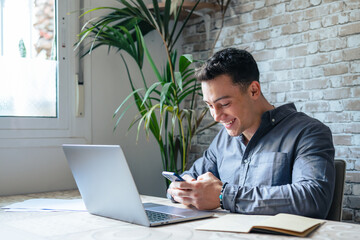 Confident man sitting at desk taking break in work with electronic documents on laptop to make...