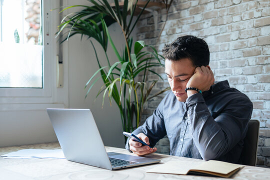 Unhappy Young Man Looking At Phone, Feeling Nervous Of Bad Device Work, Internet Disconnection, Lost Data Or Inappropriate Online Content. Anxious Male User Dissatisfied With Application Or Service..