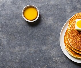 pancakes with honey and tea on a white plate. top view.