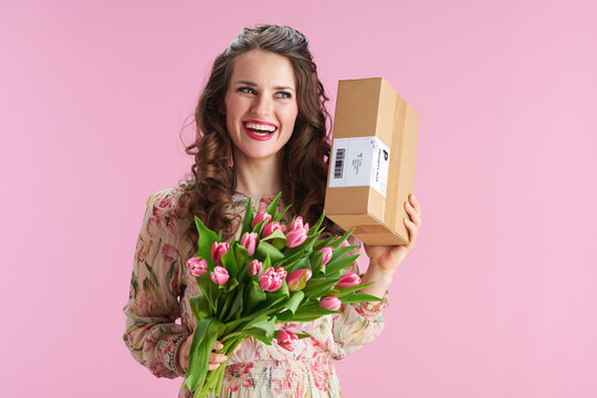 smiling stylish woman with long wavy brunette hair on pink - Powered by Adobe