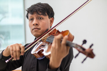 viola player, hispanic violinist or violist close up, young man playing viola. latin hispanic...