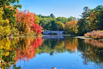 The Charles River Peninsula park in Needham, Massachusetts on a bright and sunny fall day with the...