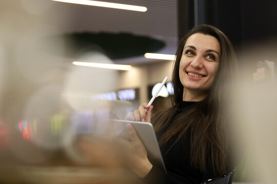beautiful business woman in office using tablet computer texting, walking in corporate office building, checking email messages online, successful executive woman.