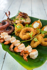 Mixed Seafood Baked. With prawns, squid, octopus, lobster and crab on banana leaf. Brazilian gastronomy.