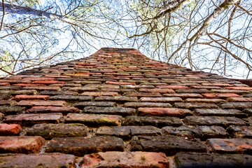 closeup of brick chimney from historic civil war era 1800s or 19th century southern log cabin in...