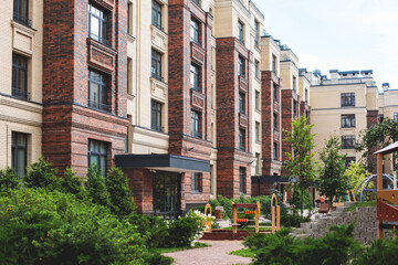 Fototapeta premium Modern european residential apartment complex yard territory, multi-story house buildings with playground and benches, contemporary scandinavian housing development, facade exterior and courtyard