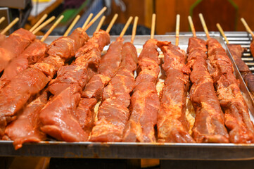 Fresh meat on skewer ready for grilling. Barbecue on fair. 