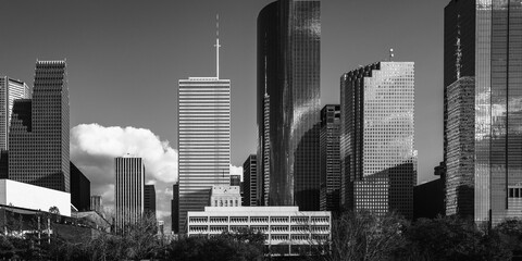 Retro-style black and white Houston Texas downtown buildings and city skyline with dramatic clouds over the metropolitan highway