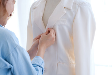 Young woman and fashion designer is create the new collections of cloth.