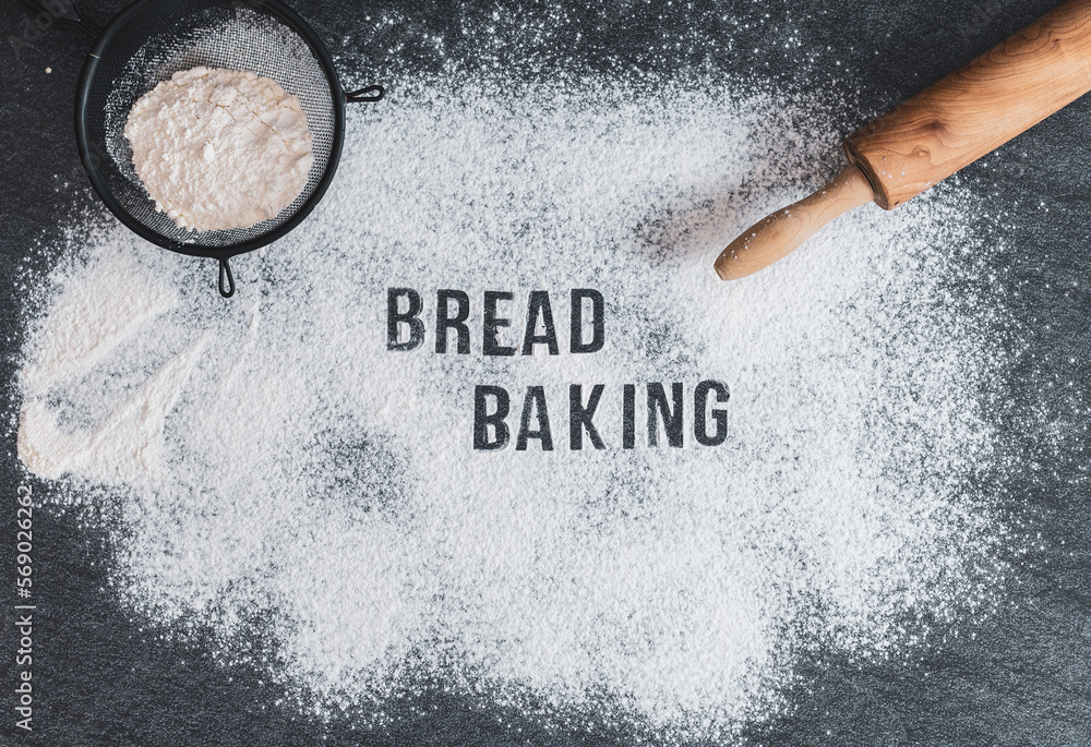 Wall mural the inscription on the flour: baking bread with a rolling pin and a sieve.