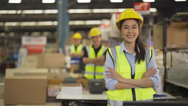Teamwork group of Asian man worker working in large warehouse retail store industry factory. Rack of stock storage. Cargo in ecommerce and logistic concept. Depot. People lifestyle. Shipment service.
