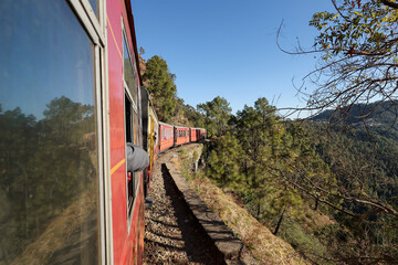 Toy train running from Kalka to Shimla or Simla capital of Himachal Pradesh north India Himalayas. Indian mountain railway	 - obrazy, fototapety, plakaty