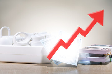 Concept of rising energy prices. . Electrical power strip, dollar banknotes and red arrow up,...